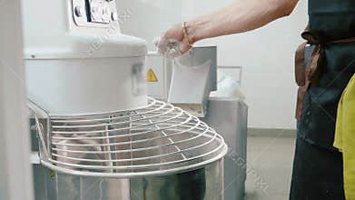 Industrial dough mixing machine kneading dough for bread, close-up