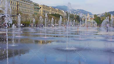 Cool trickles of water from mirror fountain refreshing and amusing passers-by