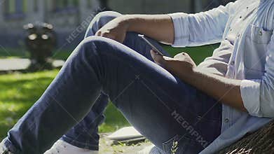 Man scrolling pages in social media, reading different news and jokes, leisure