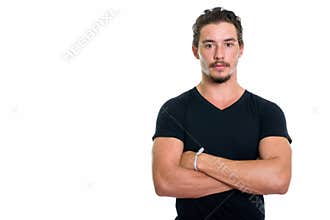Studio shot of young handsome man with arms crossed isolated aga
