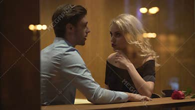 Attractive man and woman sitting in cafe and discussing relationship, quarrel