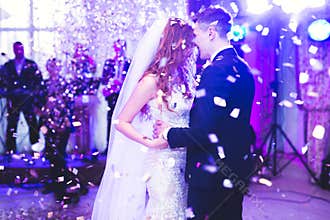 Beautiful caucasian wedding couple just married and dancing their first dance