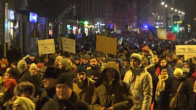 People walking on the evening street, crowds with placards