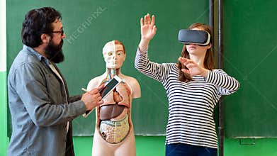 Young teacher using Virtual Reality Glasses and 3D presentation. Education, VR, Tutoring, New Technologies and Teaching Methods.