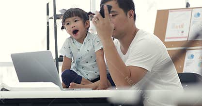 Asian modern family and little girl ,while dad works with notebook