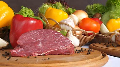Still life with raw pork meat and fresh vegetables