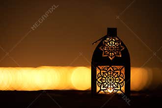 Traditional ornamental arabic candle in desert.