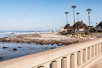 People Walk Along Shoreline Near San Elijo Campground