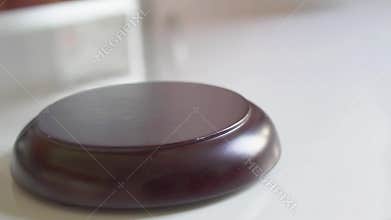 Gavel pounds on block in slow motion