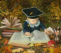 Little boy with many books in park collage