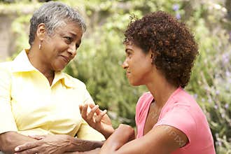 Senior Woman And Adult Daughter Chatting