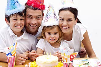 Girl blowing out candles in her birthday's day