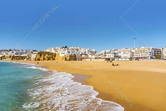 Wide, sandy beach in white city of Albufeira, Algarve, Portugal