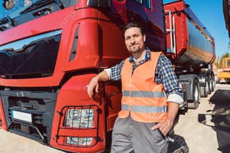 Truck driver in front of his freight forward lorry