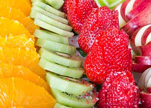 Fruit dessert apples strawberry kiwi and oranges laid out for se