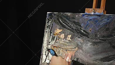 Close up of man`s hand painting still life picture on canvas in art studio