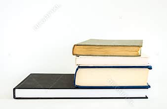 Stack of well worn books isolated on white