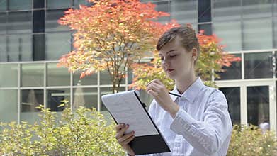 Business woman taking note on Clipboard.