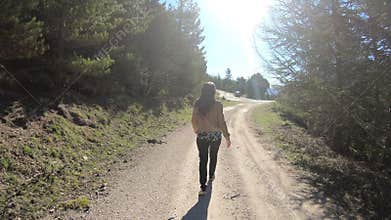 Young single woman walking on a path in the Pyrenees, France