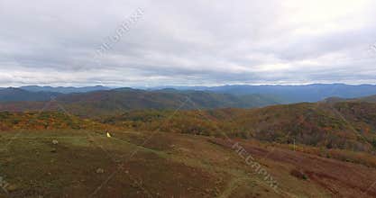 Aerial view Sunset on Max Patch MountainAppalachian Mountains, Tennessee & North Carolina, young woman in yellow dress