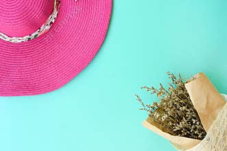 Top view of beautiful flower and summer hat