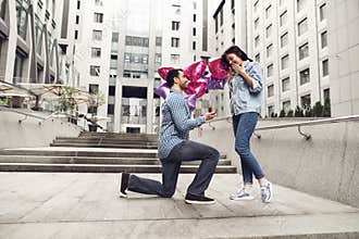 Guy makes marriage proposal to girlfriend.