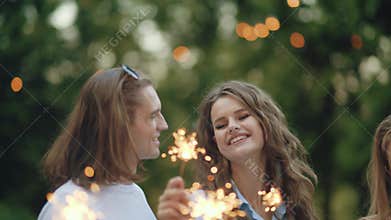 Young people at celebration party with sparklers