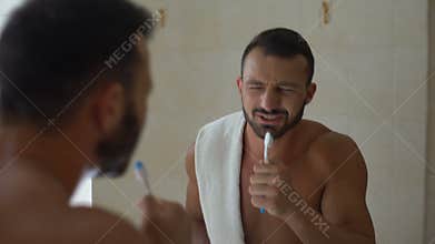 Carefree man singing with toothbrush like microphone, shattered dreams, hobby