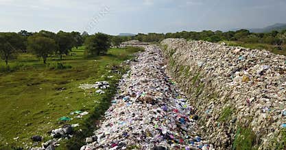 Long take bird`s eye view of garbage mountain from drone.