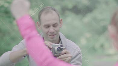 Photographer takes pictures with camera.