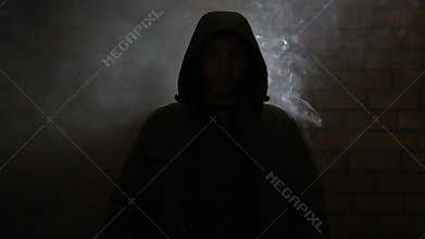 A young guy in a smoky room