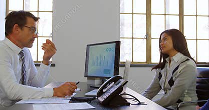 Couple discussing with adviser at his desk 4k