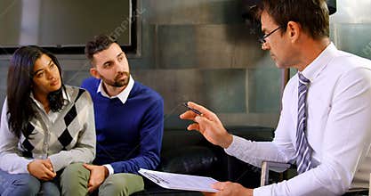 Adviser explaining agreement details to couple 4k