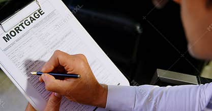 Adviser checking mortgage form in office 4k