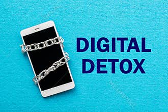 White smartphone with metal chain on blue background. Digital de