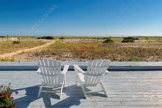 Cape Cod beach at sunset with beach chairs