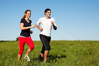 Sport couple jogging outdoors in summer