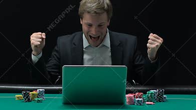 Excited man sincerely rejoicing at winning big sum of money in online casino