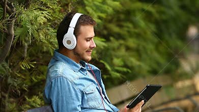 Man listening chill out music in a park