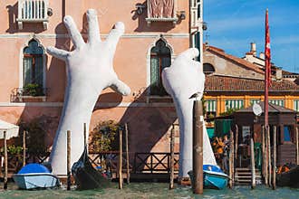 VENICE, ITALY - 07 Otober, 2017: Gigantic sculpture `Support` for the Biennale 2017. Author - Lorenzo Quinn