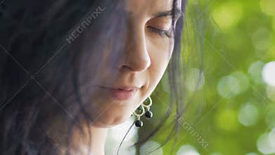 Beautiful female outdoor closes eyes feeling inner peace, quiet mind no thoughts
