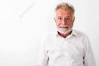 Close up of senior bearded man looking angry against white backg