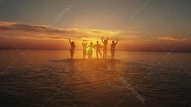 Friendship Freedom Beach Summer Holiday Concept. Beauty and joyful teenager friends having fun, dancing, spraying over