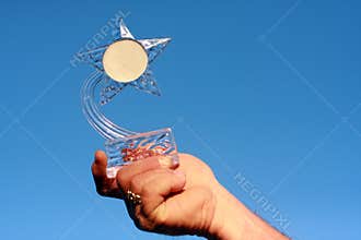 Star shaped trophy and blue sky
