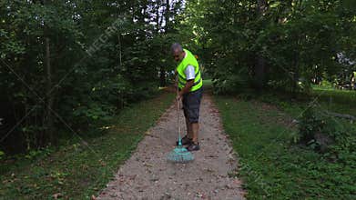 Two janitors start work in the park
