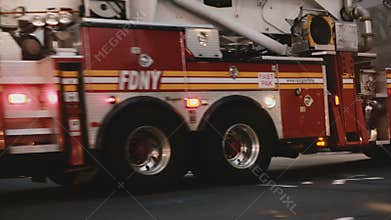 NEW YORK AUG 18 2017 - Fire truck moving fast through a busy intersection with traffic control officers in New York City