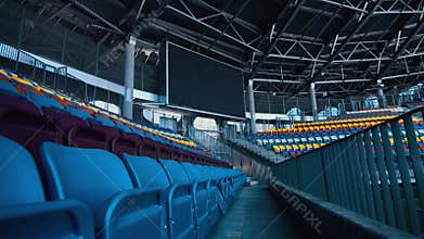 Empty sports stadium with nobody from tribune and big scoreboard