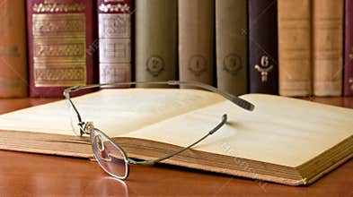 Glasses in front of an old books