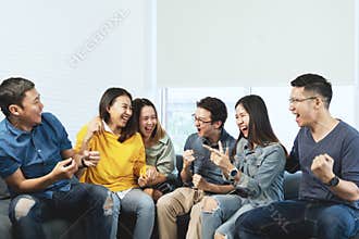 Young Attractive asian group of friends talking and laughing with happy in gathering meeting sitting at home