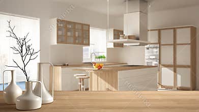 Wooden table top or shelf with minimalistic modern vases over blurred minimalist modern kitchen, white architecture interior desig